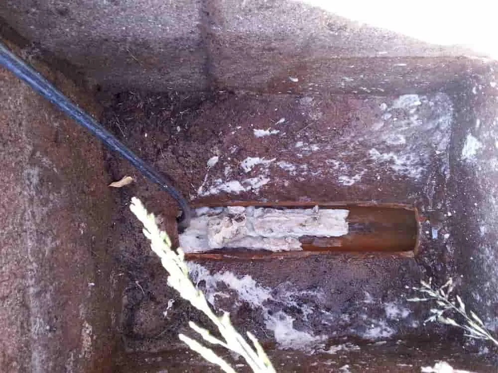 Blocked soil drain chamber with built-up waste
