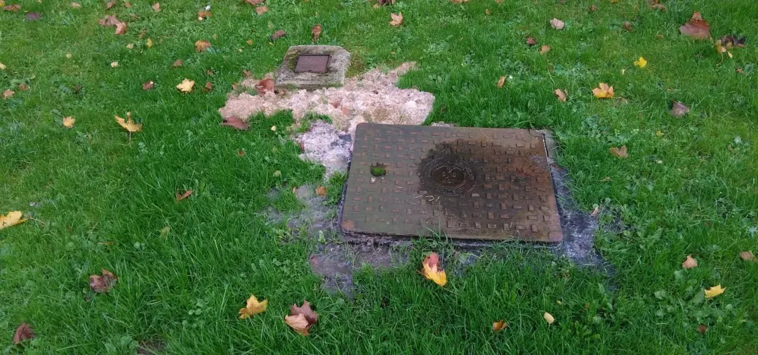 Drain manhole cover set in a garden lawn